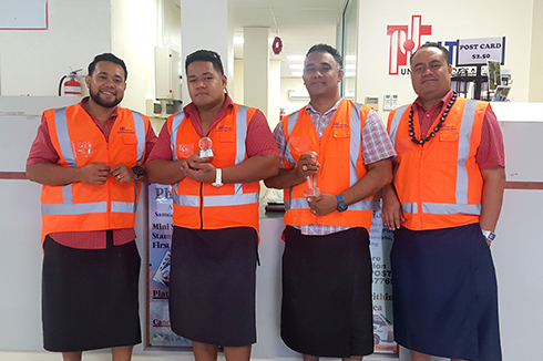 Samoa Post operational team holding Samoa's awards for EMS delivery performance